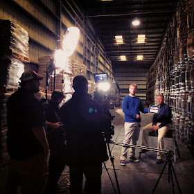 The Louisiana Culinary Trails Crew getting ready to roll  in front of a wall of aging Tabasco barrels