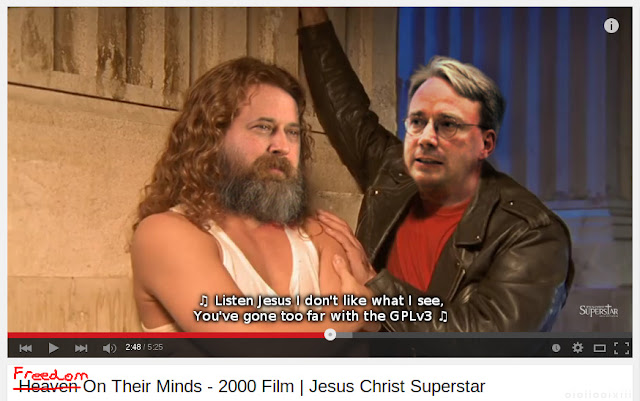 A still from Jesus Christ: Superstar musical, showing Judas with Jesus during 'Heaven on their Minds'. The image is doctored to show Jesus as Richard Stallman, and Linus Torvalds as Judas. The song title changed to: 'Freedom on their Minds'. Text on the screen is a parody of the lyrics: 'Listen Jesus I don't like what I see, you've gone too far with the GPLv3'.