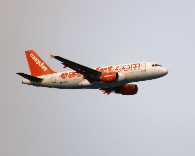 An EasyJet Airbus A319-111 over the port of Livorno