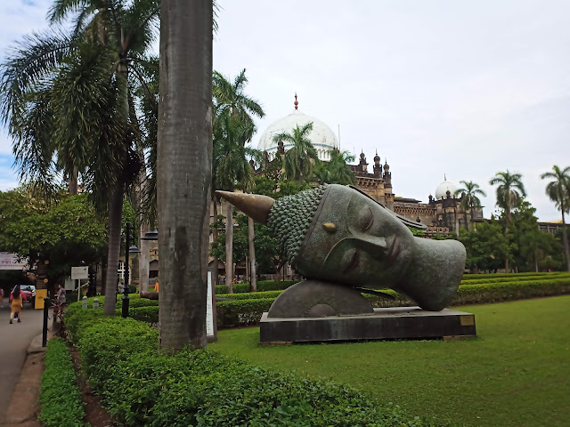 Buddha head on lawn outside Chhatrapati Shivaji Maharaj Vastu Sangrahalaya (Museum)
