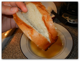 holding a slice of bread that has been sliced in the middle 