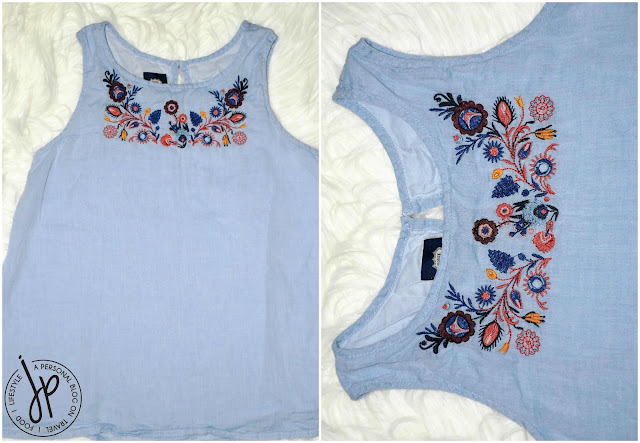 light blue girl's sleeveless blouse with floral embroidery
