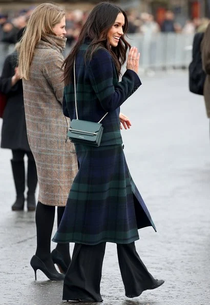 Meghan Markle wore a double-breasted tartan wool-blend coat by Burberry during Edinburgh visit. Meghan carried Strathberry Mini crossbody bag