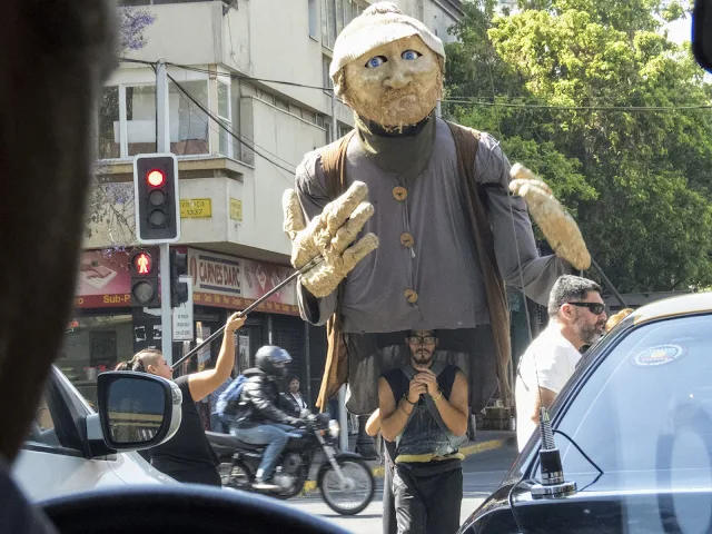 Why visit Santiago: Giant puppet performing at an intersection