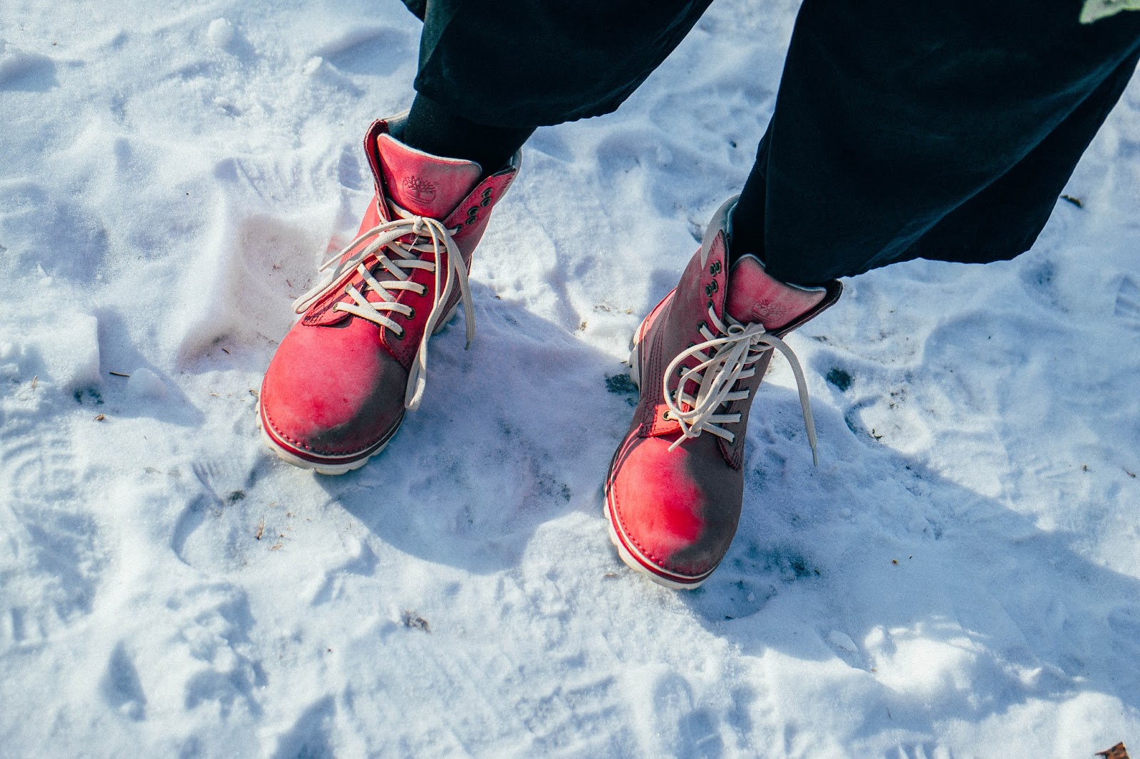Hot pink Timberland boots on snow Hot pink Timberland boots on snow