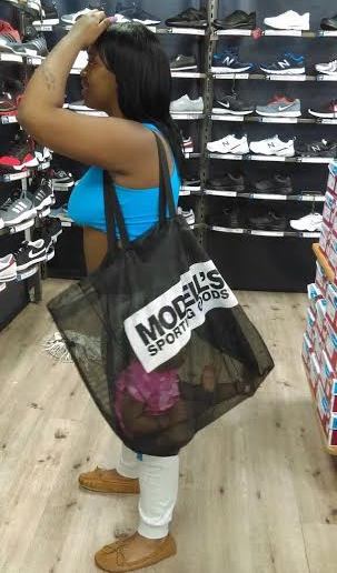 Wait...this woman put her baby inside a transparent bag while shopping?