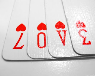 Playing cards spelling out love