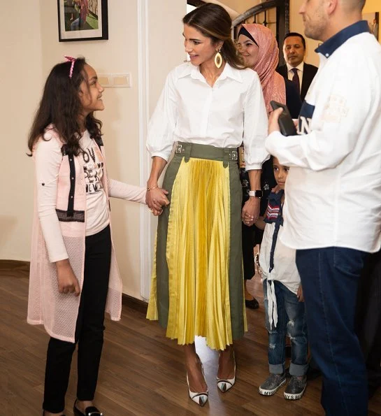 Queen Rania wore Sacai pleated midi skirt, Maison Makarem balloon shirt, Dior pumps and she carried Marni Trunk shoulder bag