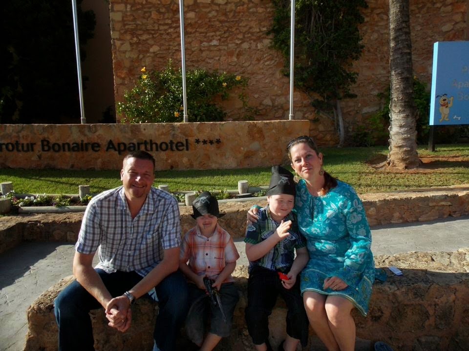 On Holiday with her Family A family outside their holiday apartment