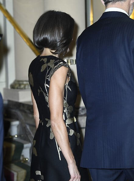 Queen Letizia wore a new embellished floral-jacquard midi dress by Dries Van Noten. gold earrings and pumps