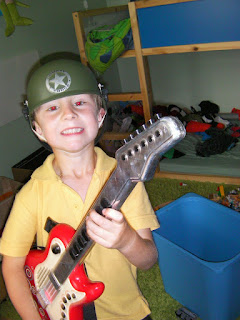 US army guitarist in messy bedroom