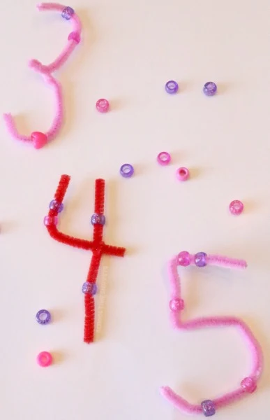 Counting beads on pipe cleaners - Laughing Kids Learn