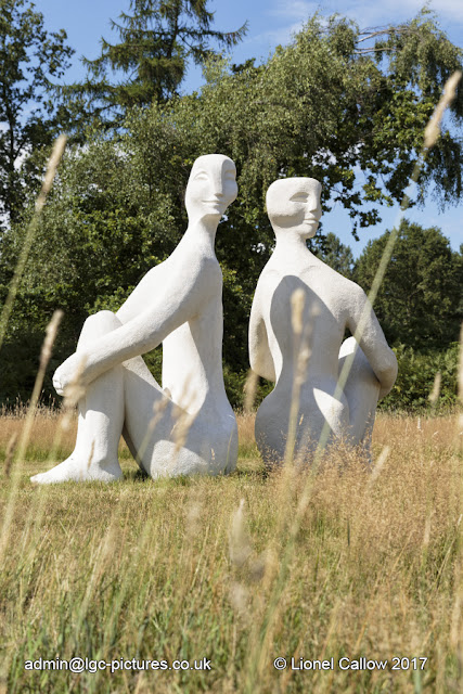 Back to Back by Lilly Henry sculpture is a stone resin of a head and shoulders profile