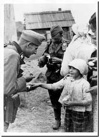 soldier socialises little  Russian girl offer food