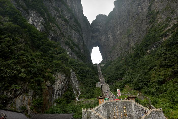 The elevation of Tianmen Mountains is 1518.6 meters (the highest one in Zhangjiajie); people may feel amazing that about 40 peaks inside the mountain area are over 1000 meters. Due to the high elevation of the mountain, the day time is longer than the night hours and the temperature on the mountains is about 10 degree centigrade lower than the Zhangjiajie city, the sunrise on the mountain is 30 minutes earlier and the sunset is 45 minutes later than it is in the city areas. Thus it is known as an endless sky without darkness.  The mountain is famous for its unique natural miracle - the Tianmen Cave; it was authorized as a national forest park in July, 1992. The door-alike cave was created after the cliff collapsing in ancient time. Tianmen Mountains is rich in Chinese culture; it is regarded as the Top 1 Heaven Mountain in the west part of Hunan province and the sprit of Wuling (an old name of the county here). This place has absorbed the essence from the nature for thousands years, therefore visiting the holy temple on the mountain – Tianmenshan Temple has become a popular way to pray for a safe and healthy life.