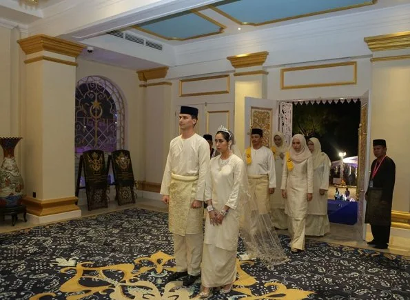 Dutchman Dennis Muhammad and Johor Princess Tunku Tun Aminah Maimunah Iskandariah Sultan Ibrahim, after wedding ceremony at the Istana Besar. wedding dress