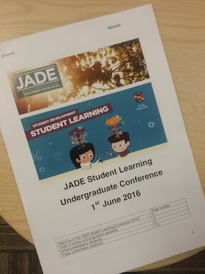 image showing the JADE conference booklet a picture of trees with the two cartoon students below