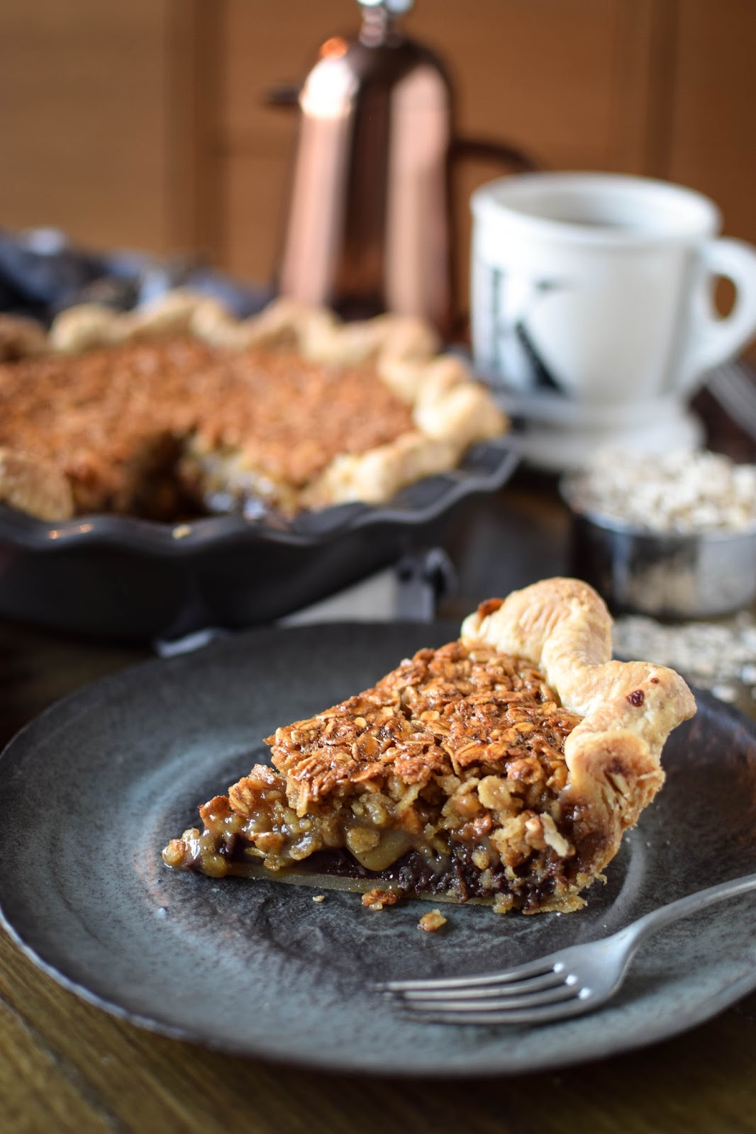 Often referred to as poor mans pecan pie this black bottomed oatmeal pie is a bit easier on the pockets that it's nutty sibling. A layer of chocolate ganache topped with a syrupy oatmeal filling sitting in a buttery crust makes this a truly rich and decadent dessert. There's nothing poor about this pie.