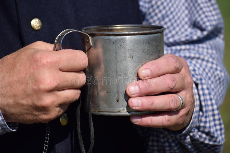 Medusa's Kitchen Tin Cup in a Beggar's Hand