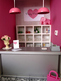 Modern one-twelfth scale miniature bar scene in shades of pink, white and grey.