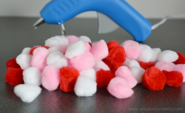 Easy Pom Pom Valentine Wreath Tutorial at artsyfartsymama.com #ValentinesDay