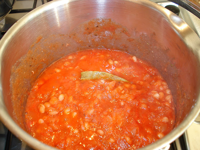 Beans in a tomato sauce cooking on the hob