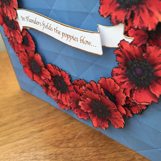 diagonal shot of poppies card for Memorial Day. Shows shadows of background embossing and layered flowers.