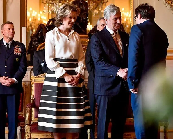 Queen Mathilde held a new year's reception at the royal palace in Brussels. Queen Mathilde wore a striped midi skirt by Natan