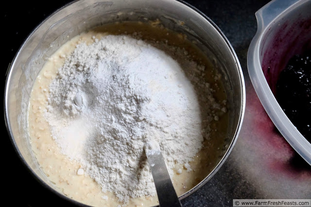 image showing the adding of dry ingredients to soaked oats while making raspberry oatmeal muffins