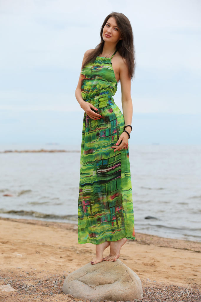 Slender teen Ganna A drops her long dress to air perfect tits on the beach