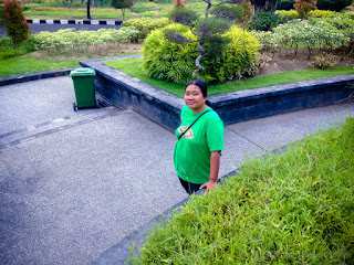 Sweet Woman Smile Walking Around The Sweet Garden Of The Parking Lot At Badung, Bali, Indonesia