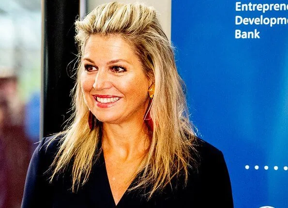 Queen Maxima wore Natan crepe jumpsuit. Queen Maxima's outfit is by Belgian fashion house Natan. red sandals and clutch