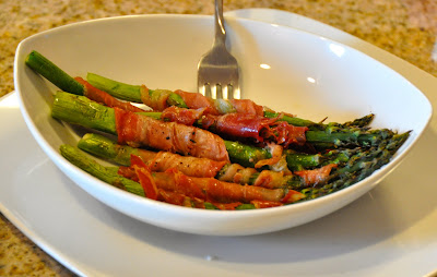 prosciutto wrapped around asparagus in a bowl