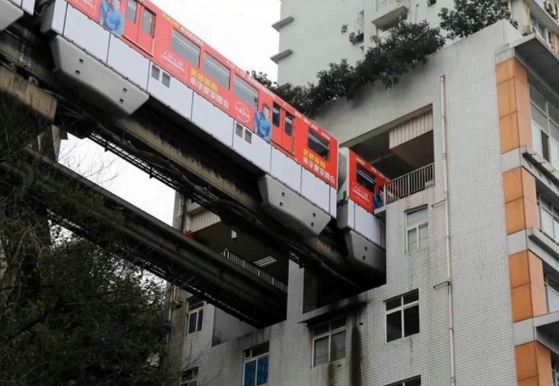 A Train In China's Mountain City (Chongqing) Runs Through An Apartment Building