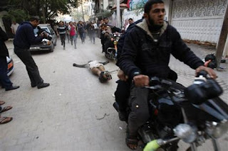 Palestinians drag body of suspected spy behind motorcycles in Gaza Palestinians drag body of suspected spy behind motorcycles in Gaza