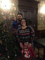 Family in front of Christmas Tree