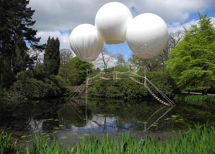 French artist Olivier Grossetête used three enormous helium balloons to float a rope bridge over a lake in Tatton Park, a historic estate in north-west England. Oliver Grossetête created Pont de Singe, which means "monkey bridge", for the Tatton Park Biennial, which this year was themed around flight. Located in the park's Japanese garden, the structure comprised a long rope bridge made of cedar wood held aloft by three helium-filled balloons. The ends of the bridge were left to trail in the water. Though visitors weren't allowed to use the bridge, it would theoretically be strong enough to hold the weight of a person, according to Grossetête.