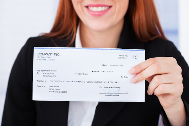 Business woman holding check from company