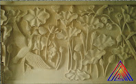 Relief bunga lotus dan burung bangau dibuat dari batu alam paras jogja atau batu putih