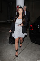 Kim Kardashian pregnant in a stripped short dress