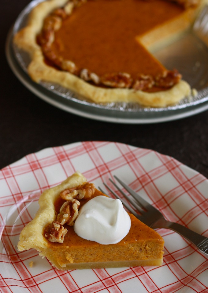 a slice of fresh pumpkin pie with sugarless whipped cream on top