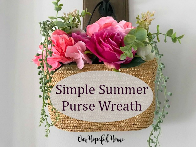 straw purse filled with flowers hanging on door