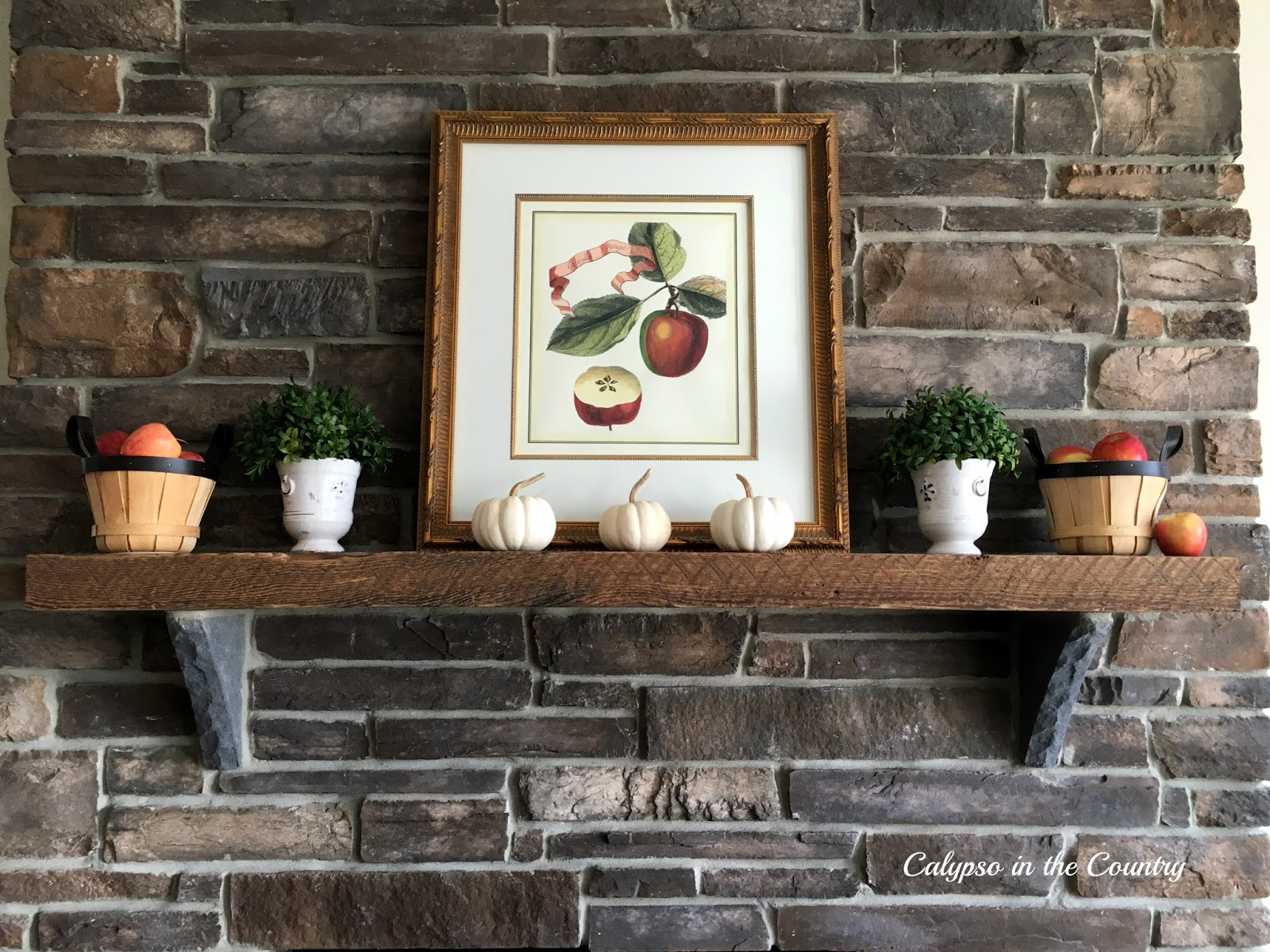 Rustic Mantel Decorated for Fall with Apples and Pumpkins