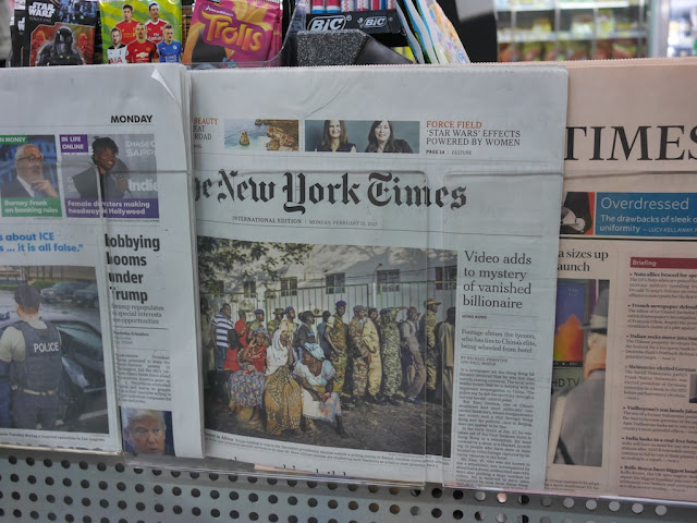 front page of New York Times magazine with piece title "Video adds to mystery of vanished billionaire" at a 7-Eleven in Hong Kong