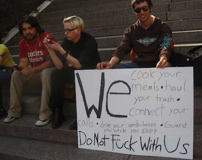Handmade sign saying We do all your work for you and guard you at night, don't fuck with us
