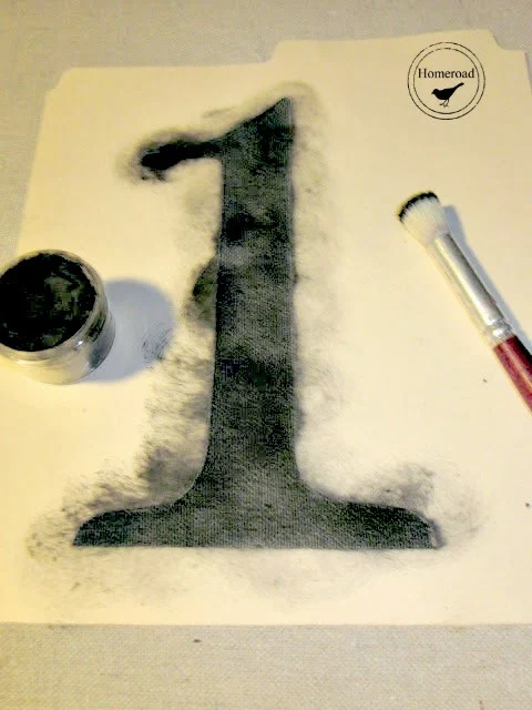 stenciling the number 1 with black paint