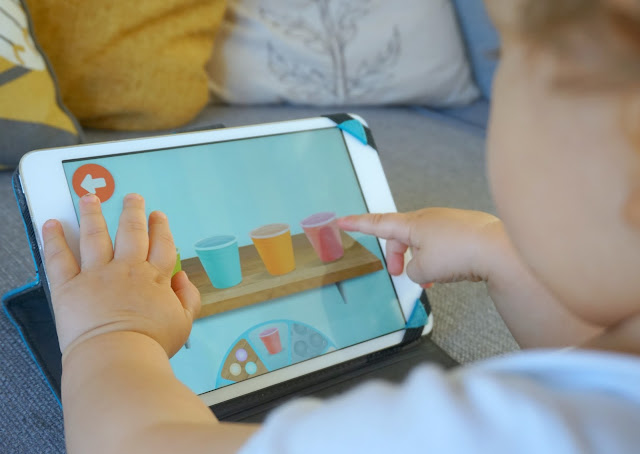 close up photo of a toddler boy playing on an ipad