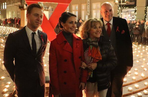 The Danish AIDS Foundation at Trinitatis Church in Copenhagen. candle lighting event, She wore a red wool coat by Maje