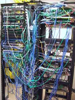 Rack of equipment entangled in a messy mass of cables