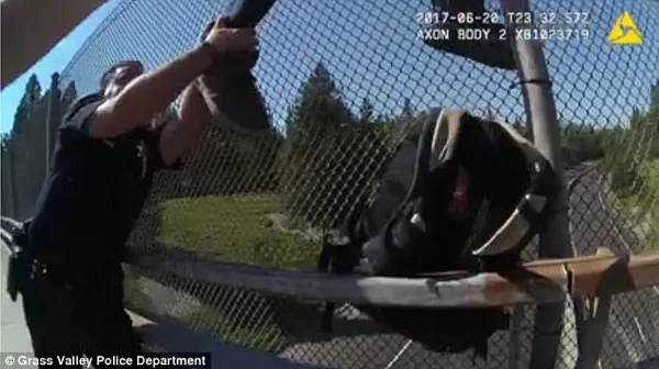 This is the heart-stopping moment two police officers raced to stop a man from committing suicide by jumping from a highway overpass.Body camera footage from one of the Grass Valley officers in northern California starts by showing a man leaning against the wire fence of an overpass on Tuesday afternoon